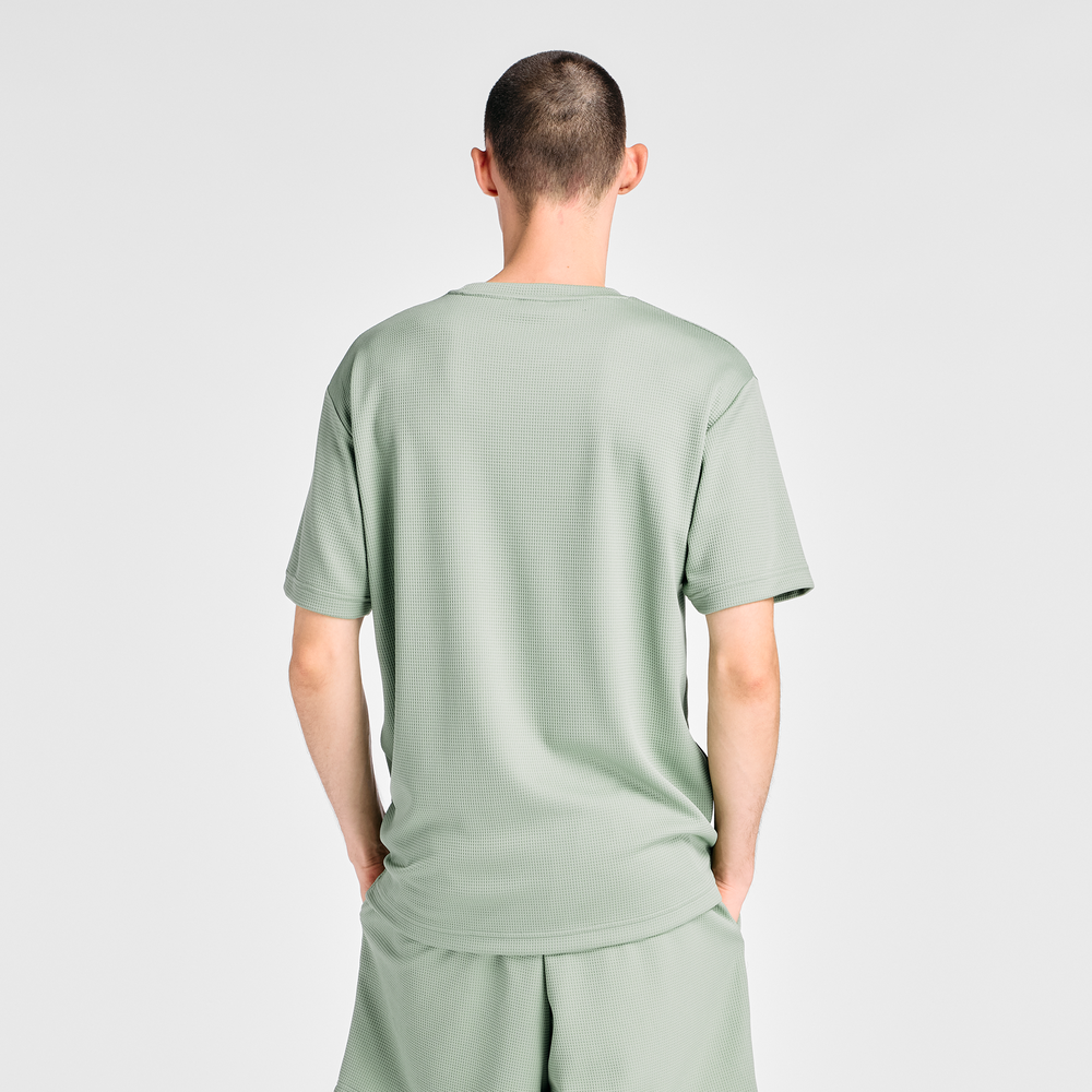 Férfi futópóló New Balance MT6100FRAAR – zöld